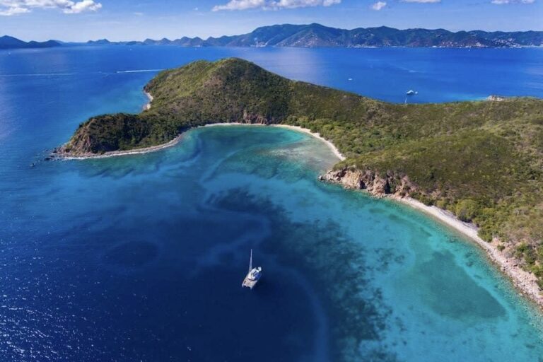 BVI yacht charter - catamaran anchored alone in a secluded anchorage.