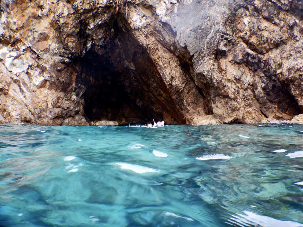 Snorkelers in a cave at Norman Island
