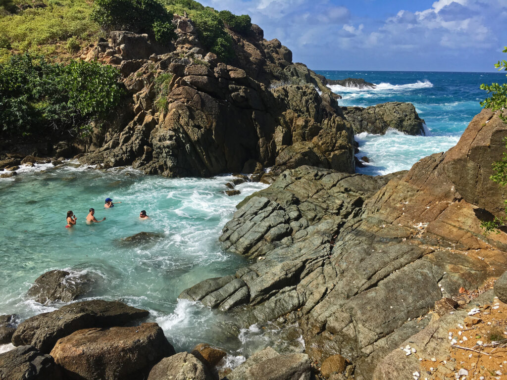 Tourists enjoy swimming in the bubbly pool on Jost Van Dyke British Virgin Islands