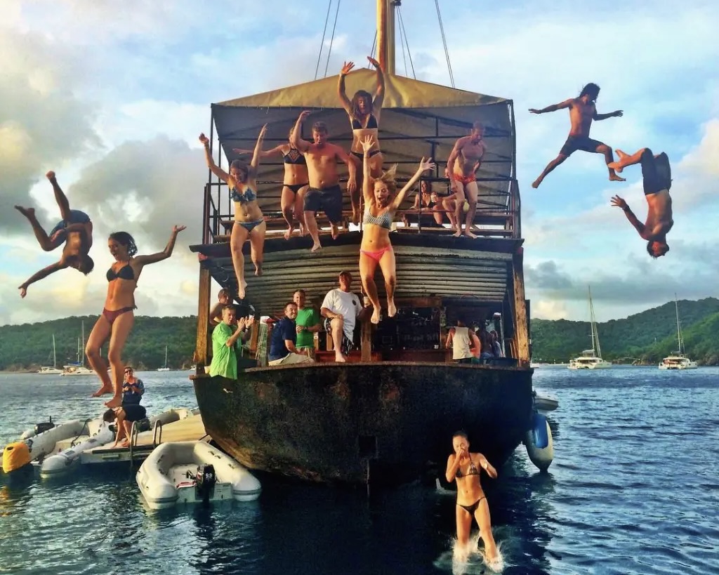 People jumping off the Willy T floating pirate bar, BVI
