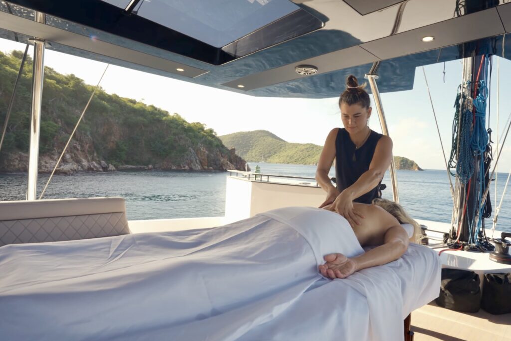 guest getting massage onboard catamaran TRYST