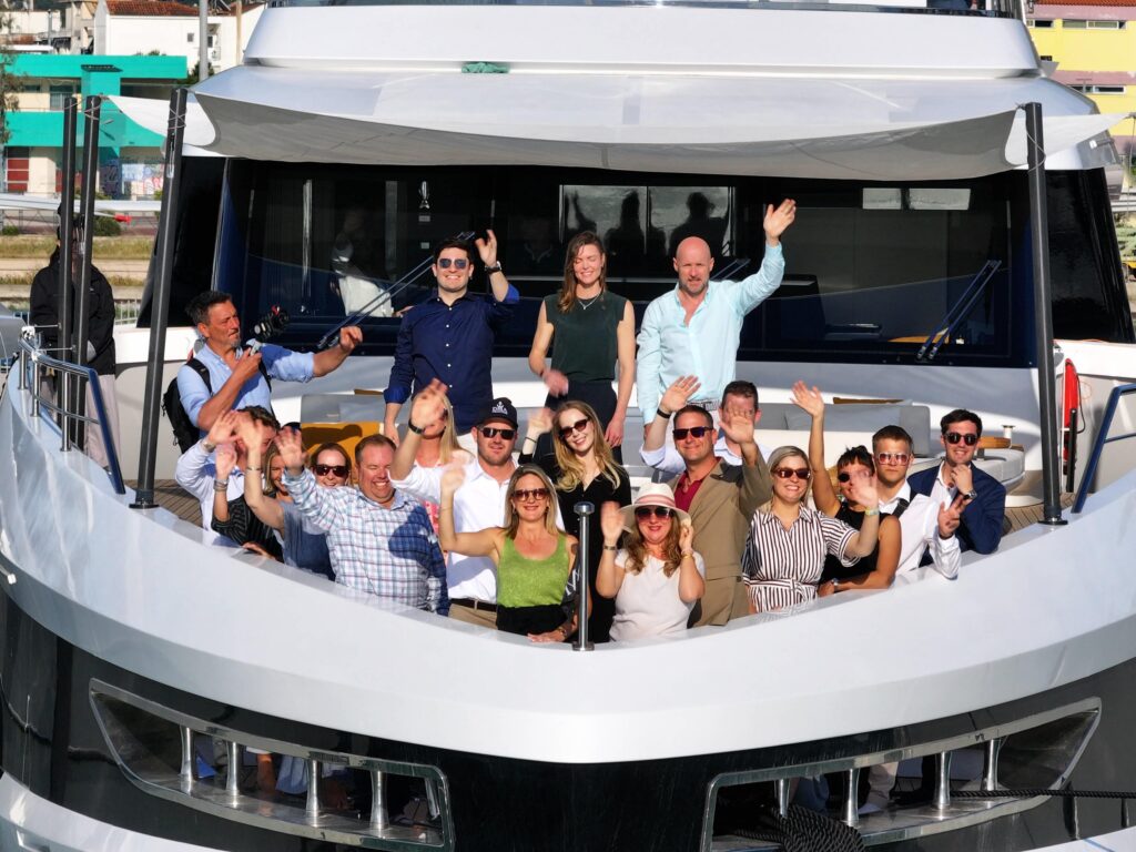 DMA Yachting team on bow of boat