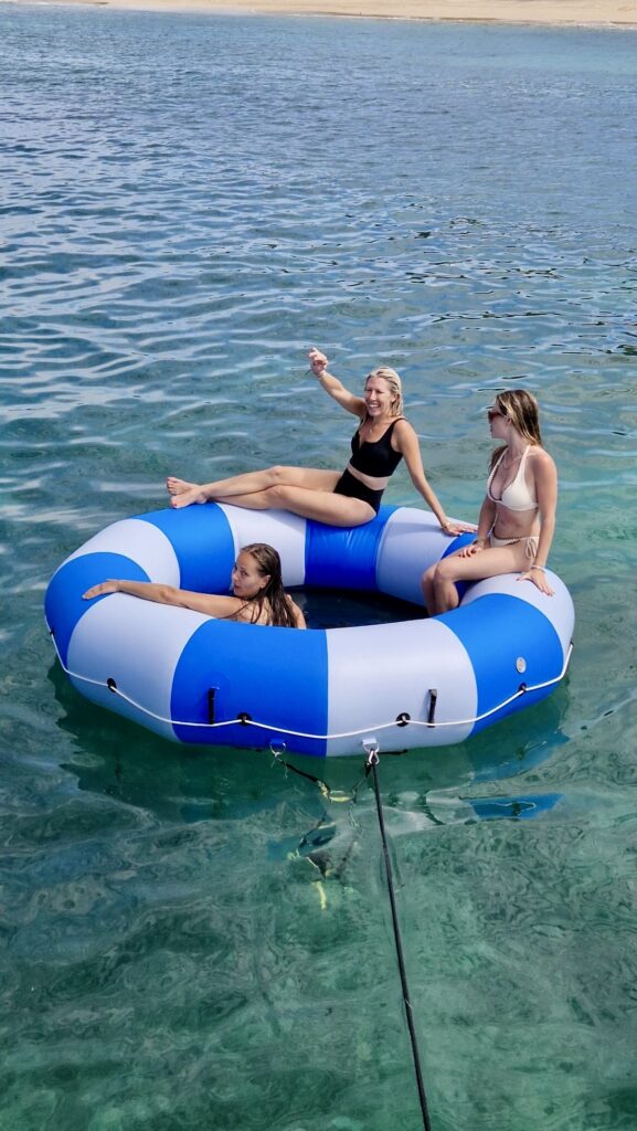 Klara, Susannah and Casey sitting in the floating donut, catamaran INDULGANCCE, BVI