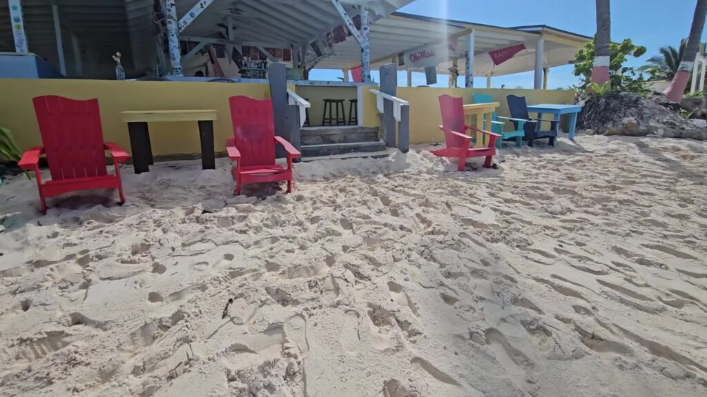 Red beach chairs at Cow Wreck Beach Bar, Anegada, November 2025
