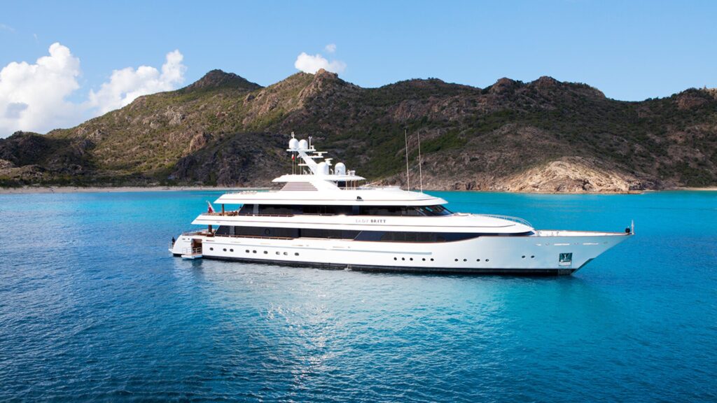 LADY BRITT, the 63 m Feadship superyacht, at anchor off a green island