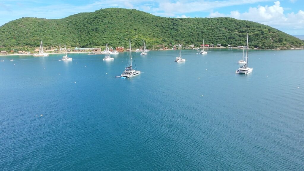 The mooring field in Manchioneel Bay, Cooper Island, with the Beach Club on the shore, from the air, November 2025