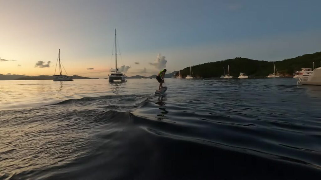 An e-foil through the anchorage in the Bight at dusk, Norman Island, November 2025