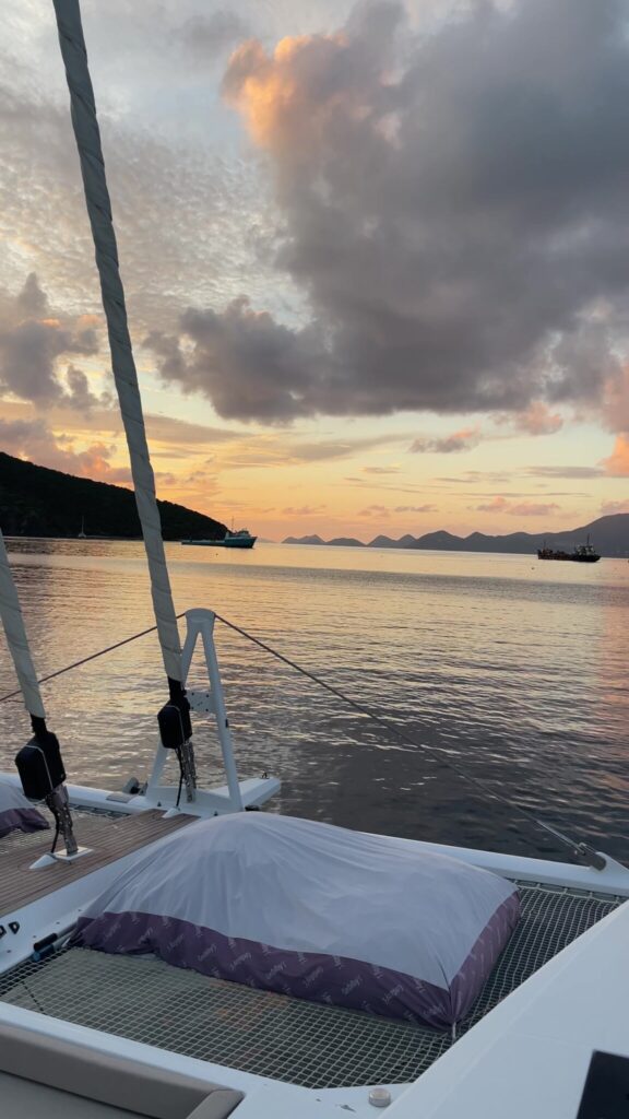 Sunset from the bow of the catamaran at anchor in Great Harbour, Peter Island, November 2025
