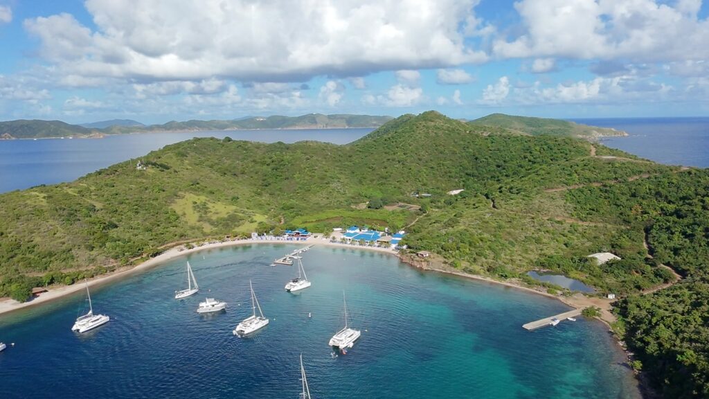 Catamarans anchored in the Bight, Norman Island, seen from above the Pirates Bight beach, November 2025