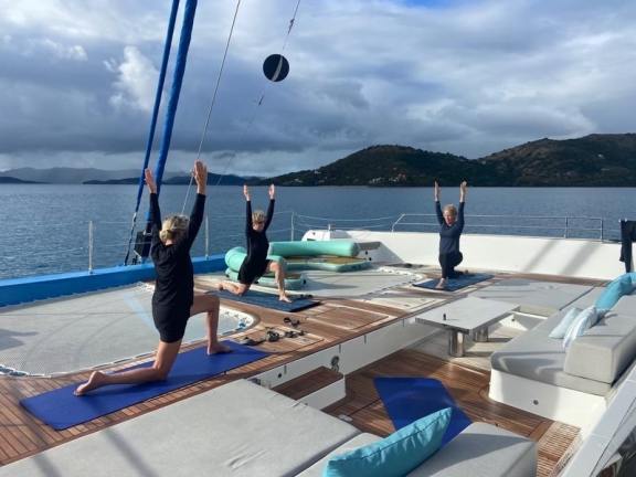Guests doing Yoga on the foredeck of Catamaran Ohana in the BVI