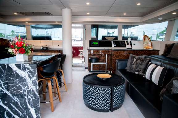 The interior of the luxury catamaran Lena is quite special, featuring strong contrasting colors that give it a cool, classy appearance.