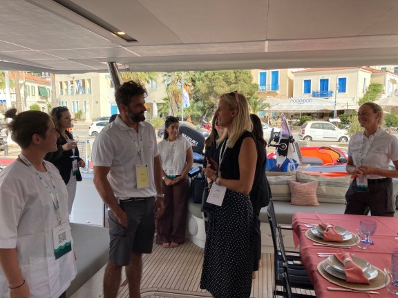Broker Sarah Klische speaking to crew onboard Catamaran Namaste