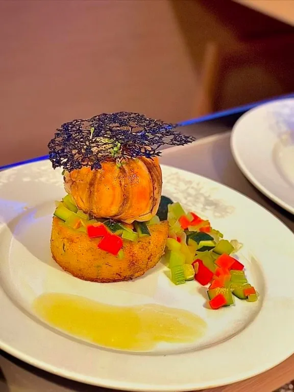 Onboard Olivia Charles Chef Emma served locally sourced butter poached lobster tails with fresh herb polenta and beurre monte.