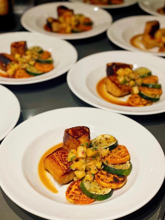 Fresh caught wahoo marinated in a sweet and savory honey ginger sauce complimented by roasted sweet potatoes, zucchini, and a fresh mango pineapple ginger salsa.