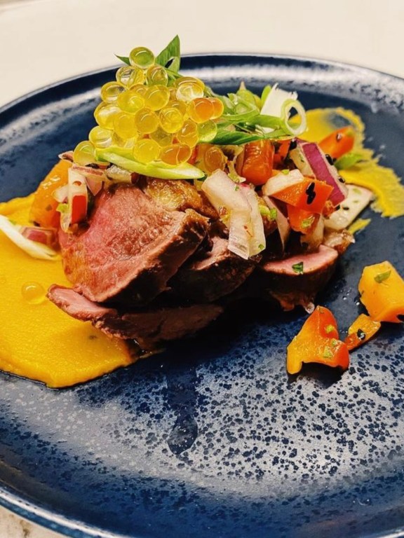 Seared 7 spiced duck with roasted sweet potato & red pepper purée, papaya, pepper, scallion, lime & sesame salsa and passionfruit pearls