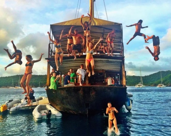 People jumping off the Willy T floating pirate bar, BVI