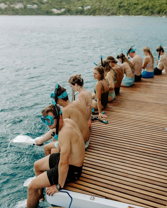 Charter Catamaran Ohana, guests on the swim platform getting ready for snorkeling