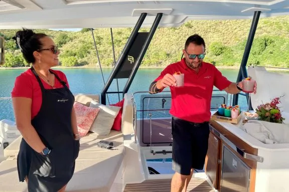 Mike serving cocktails onboard crewed catamaran INDULGANCE, BV