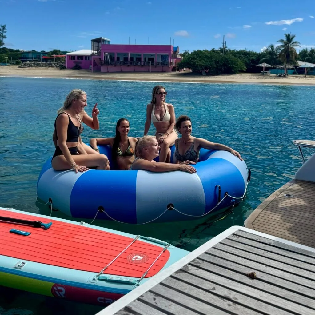 Women on floating donut off stern