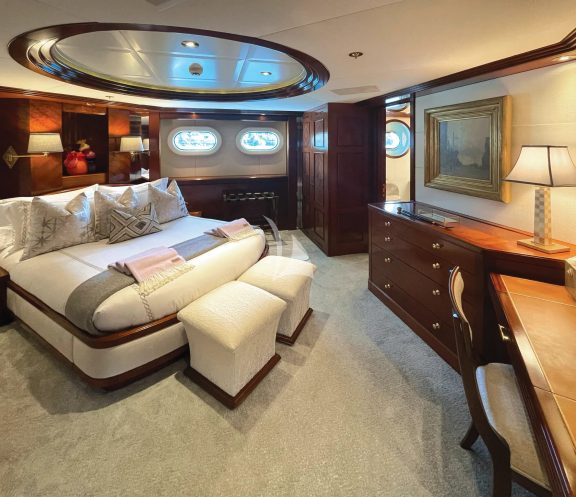 Perceptive of guest Queen stateroom with luxurious textiles, cozy lighting and comfortable seating