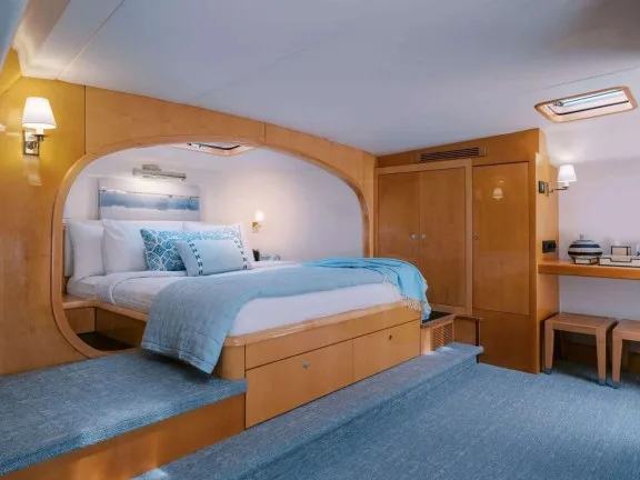 Full-beam master cabin with warm wood finish on BVI catamaran AVANTI, a 74 ft Privilege