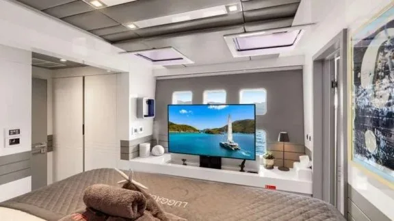 Master cabin with cinema-wall TV on BVI catamaran MAVERICK, a Sunreef 70