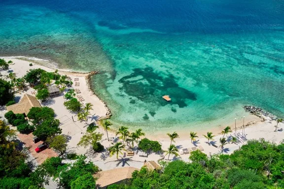 The beach and reef of the Aerial BVI private island wellness retreat seen from above