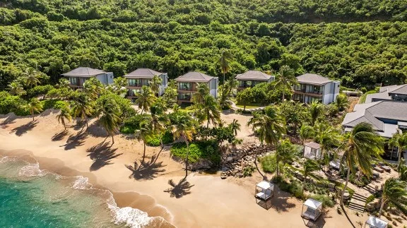 Beachfront rooms and palm-lined sand at Peter Island Resort in the BVI