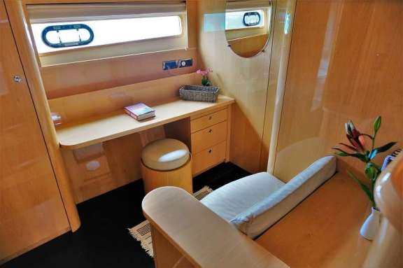 Primary seating area with desk and standing closets