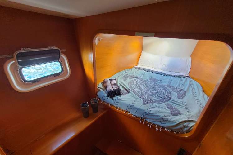 Port forward Stateroom Queen Bed. All rooms have 2 fans and a hatch to catch natural ocean breezes.