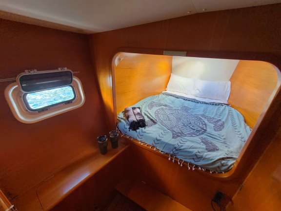 Port forward Stateroom Queen Bed. All rooms have 2 fans and a hatch to catch natural ocean breezes.