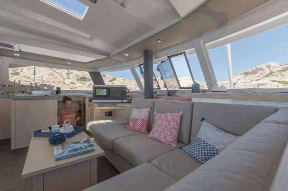Spacious salon with steps down to the starboard suite